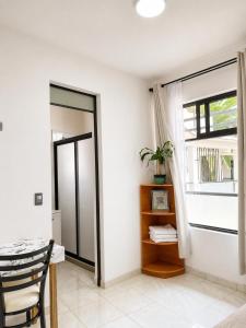 a dining room with a table and a window at La Palma Coliving in San Lucas Xoloc