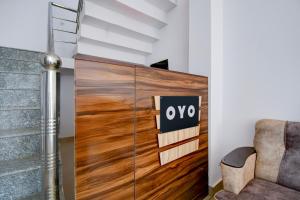 a wooden door in a room with a chair at HOTEL O SAV INN in Bhauli