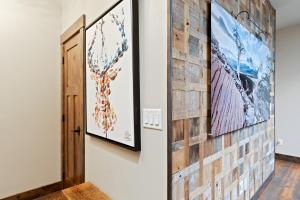a hallway with paintings on the wall and a door at Central Loft 303 in Whitefish