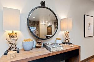 a mirror on top of a wooden table in a room at Central Loft 303 in Whitefish