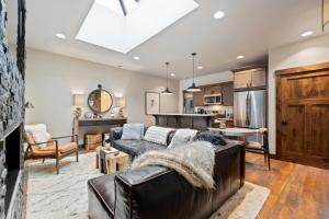 a living room with a couch and a kitchen at Central Loft 303 in Whitefish
