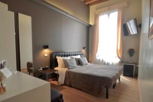a bedroom with a bed and a large window at Albergo al Tiepolo in Venice +58 photos
