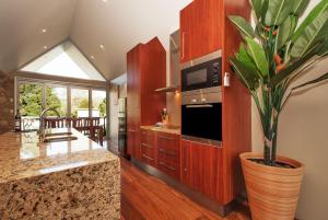 a kitchen with a plant in a large vase at Centenary Peaks in Bright