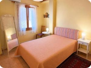 a small bedroom with a bed and a window at Like a local in Chios Castle in Chios