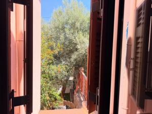 an open window of a building with a person walking down the stairs at Like a local in Chios Castle in Chios