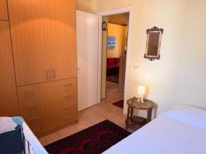 a bedroom with a bed and a dresser and a mirror at Like a local in Chios Castle in Chios +7 photos