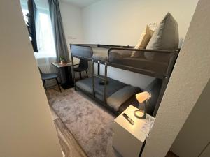 a small room with a bunk bed and a desk at City Hub Room 27 - Coffee for free - in Karlsruhe