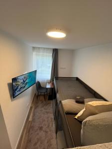 a bedroom with two beds and a desk with a window at City Hub Room 27 - Coffee for free - in Karlsruhe