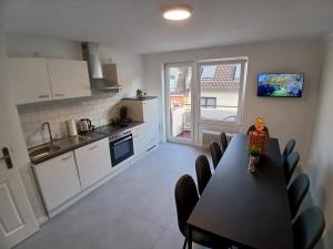 a kitchen and dining room with a table and chairs at City Hub Room 27 - Coffee for free - in Karlsruhe +22 photos