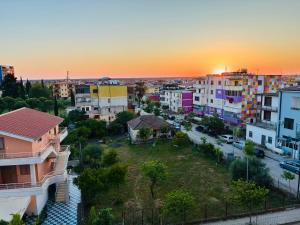 an aerial view of a city at sunset at Arc Apartment Family - City Center in Divjakë