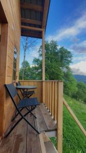 a porch of a cabin with a picnic table on it at Towers Inn Cottage in Mestia +20 photos