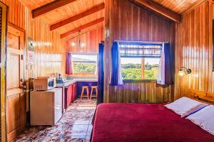 a bedroom with a bed and a kitchen in it at Hotel Mango Valley in Grecia