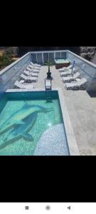 a large swimming pool with chairs and a table at Eki 2026 VIP in Donji Štoj