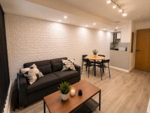 a living room with a couch and a table at One bed apartment - City Centre in Manchester