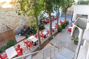 an overhead view of a patio with red chairs and tables at Zuma Hotel Cyprus - Turkish Side in Nicosia