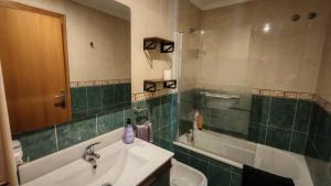 a bathroom with a sink and a bath tub at Casa Mediterrània in Xeraco +59 photos