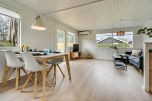 a living room with a table and white chairs at C11347-Tarm-Baeverstien-8 in Tarm +24 photos