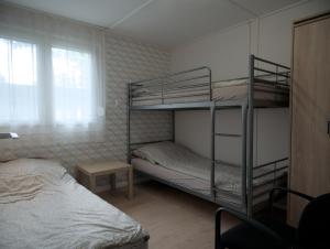 a bedroom with two bunk beds and a bed at Rózsa Villa Vadkerti tó in Soltvadkert