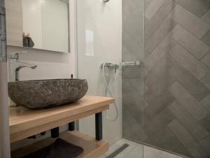a bathroom with a sink and a glass shower at Rózsa Villa Vadkerti tó in Soltvadkert +13 photos