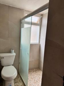 a bathroom with a toilet and a window at HOTEL FLAMINGOS DE CIUDAD GUZMAN in Ciudad Guzmán +19 photos