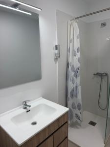 a white bathroom with a sink and a shower at Urban Stay Maspalomas in San Bartolomé +28 photos