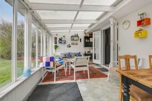 a screened in porch with a table and chairs at C11712-Bork-Havn-Magevaenget-17 in Falen +26 photos