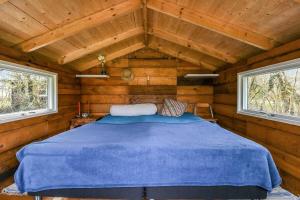 a bedroom with a blue bed in a wooden cabin at C11712-Bork-Havn-Magevaenget-17 in Falen