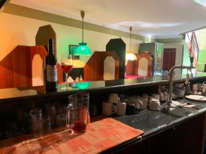 a kitchen with a counter with a bottle of wine at Várfal Panzió és Wellness in Pécs +54 photos