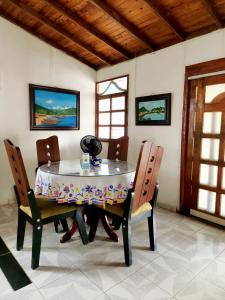 a dining room with a table and two chairs at Cabaña Florez in Santa Marta