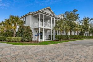 a white house with palm trees and a driveway at North Beach Resort & Villas in Myrtle Beach
