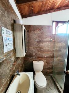 a bathroom with a toilet and a sink at Cabaña Florez in Santa Marta +19 photos
