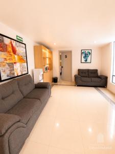a living room with a couch and a table at Hotel Casa Galeana Centro con Estacionamiento Privado in Aguascalientes