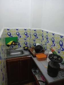 a kitchen with a sink and a counter top at Lovely hotel in Al Qābūţī