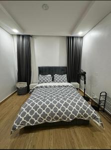 a bedroom with a large bed with black curtains at Executive Apartment in Anthony in Lagos +5 photos