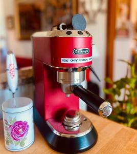 a red coffee machine sitting on top of a table at Le Palm House has two bedrooms with the breathtaking view over lake Como in Perledo +37 photos