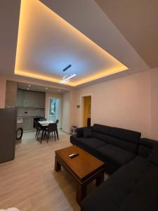 a living room with a couch and a table at Rajan Rooms in Vlorë