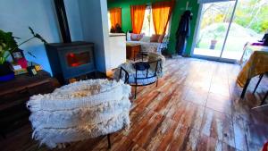 a living room with a wooden floor and a fireplace at La Elegida Villars in General Las Heras