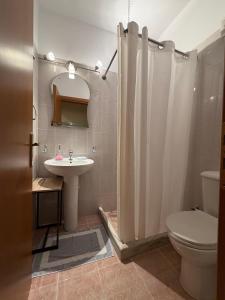 a bathroom with a sink and a toilet and a shower at Το Είδωλον Sea Maisonettes & Studio in Ancient Epidauros +31 photos