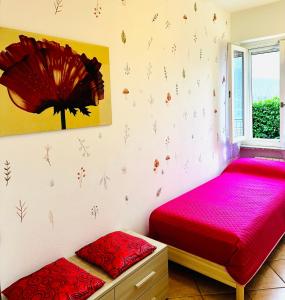 two beds in a room with flowers on the wall at Le Palm House has two bedrooms with the breathtaking view over lake Como in Perledo