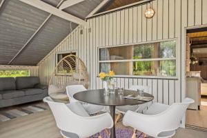 a dining room with a table and white chairs at 40572-Juelsminde-Pot-Strandby-134 in Sønderby +21 photos