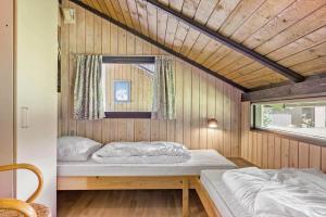 a small bedroom with two beds in a house at 40572-Juelsminde-Pot-Strandby-134 in Sønderby