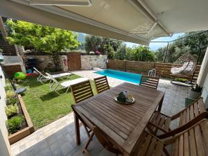 a patio with a table and chairs and a pool at Abigails Pool House in Kallirákhi