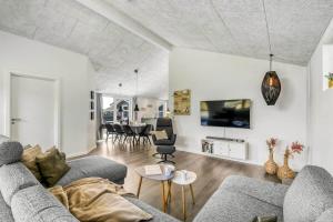 a living room with a couch and a tv at C11349-Tarm-Stikkelsbaervej-43 in Tarm