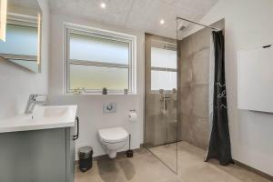 a bathroom with a shower and a toilet and a sink at C11349-Tarm-Stikkelsbaervej-43 in Tarm +32 photos