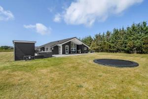 a house with a trampoline in the yard at C11349-Tarm-Stikkelsbaervej-43 in Tarm