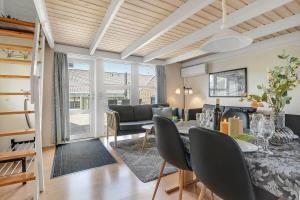 a living room with a table and chairs and a couch at C11726-Hemmet-Vester-Faelled-120-E1 in Hemmet
