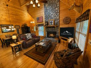 a living room with a couch and a fireplace at Lords View in Mineral Bluff