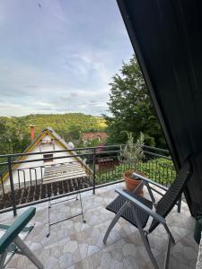 a balcony with chairs and a view of a house at Two Olives Vacation Homes in Slatina Varoš