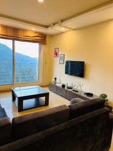 a living room with a couch and a coffee table at Apartment In Ayubia in Naka