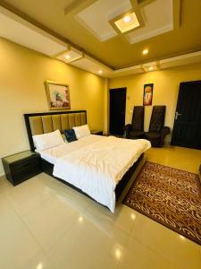 a bedroom with a large bed and a couch at Apartment In Ayubia in Naka